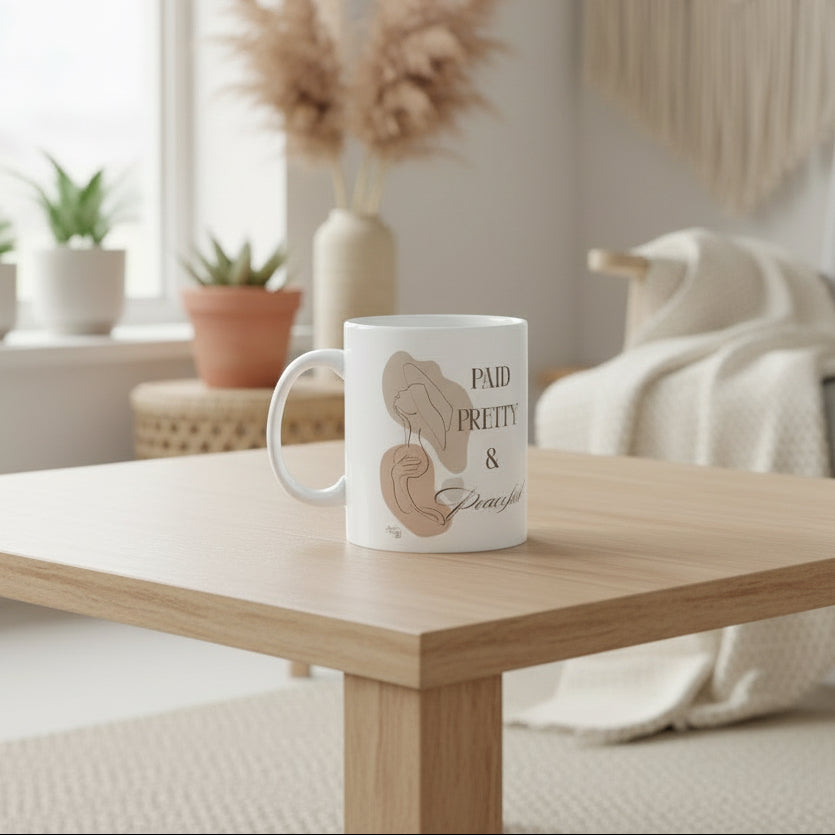 White mug with artistic illustrations and text on a white background